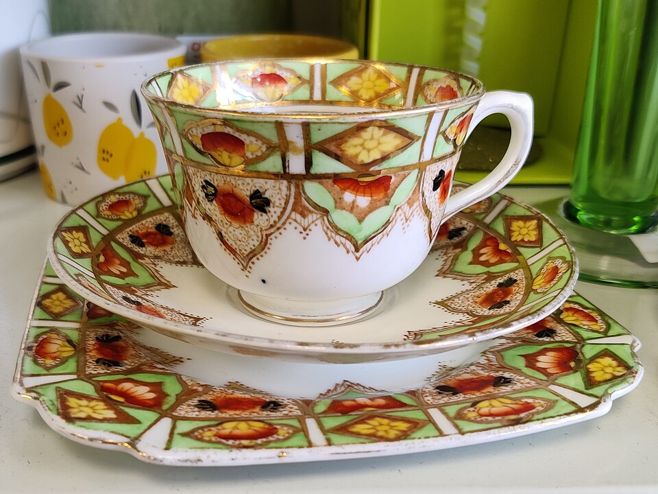 A decorated china teacup, saucer and tea plate