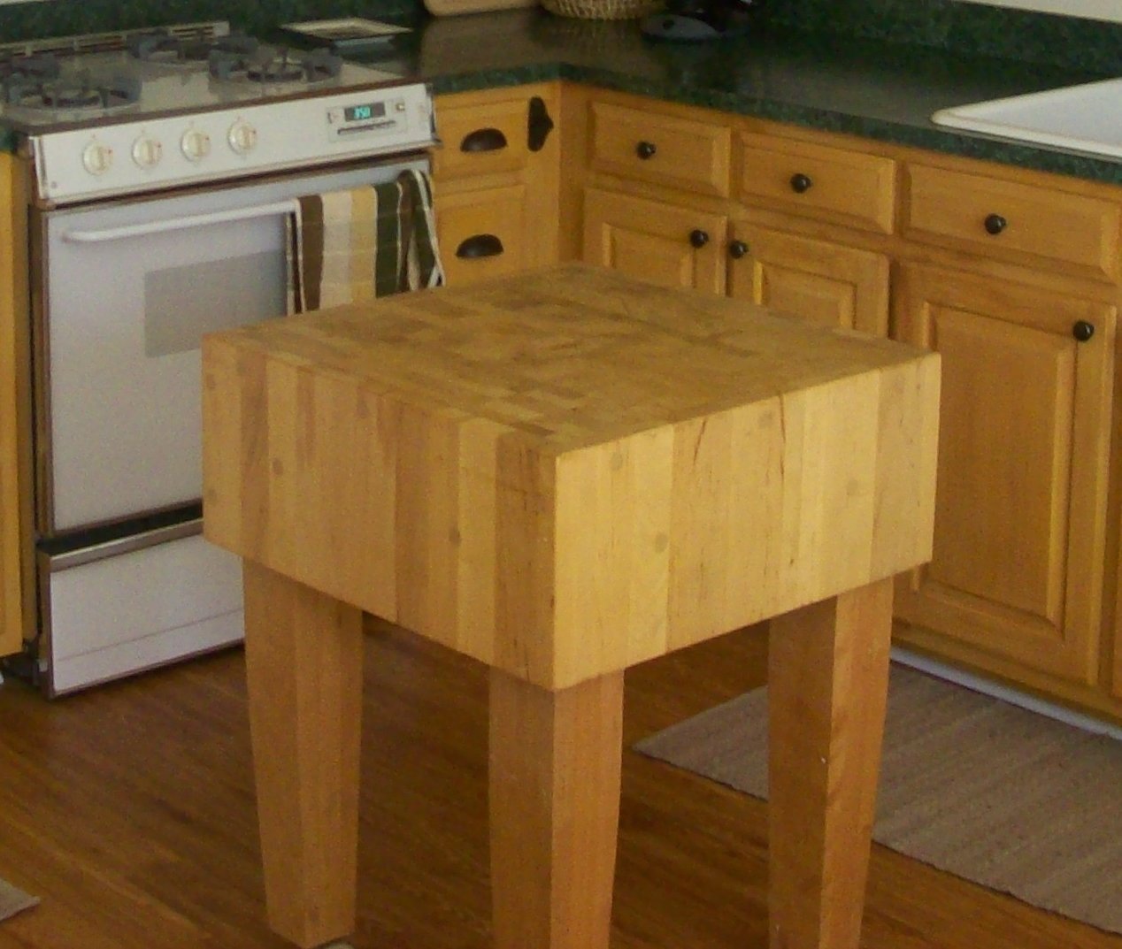 A freestanding butcher's block in a kitchen