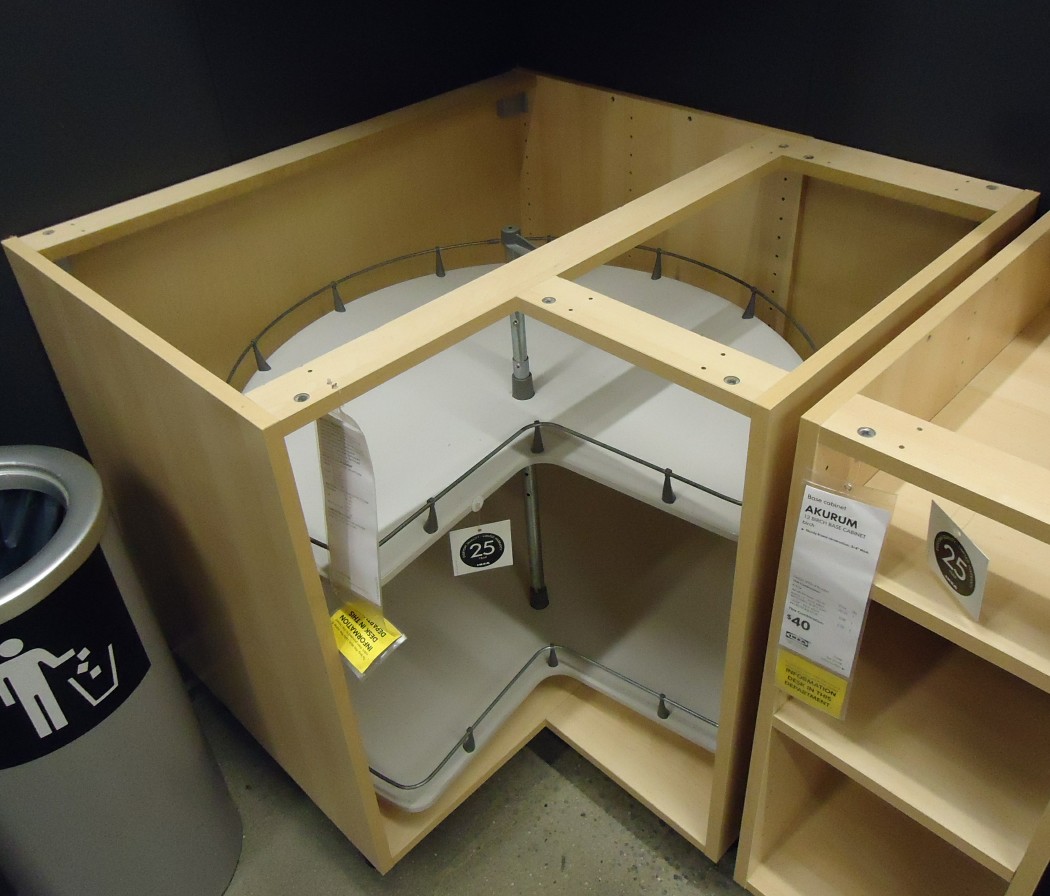 A corner kitchen cabinet with carousel shelves, shown without its worktop