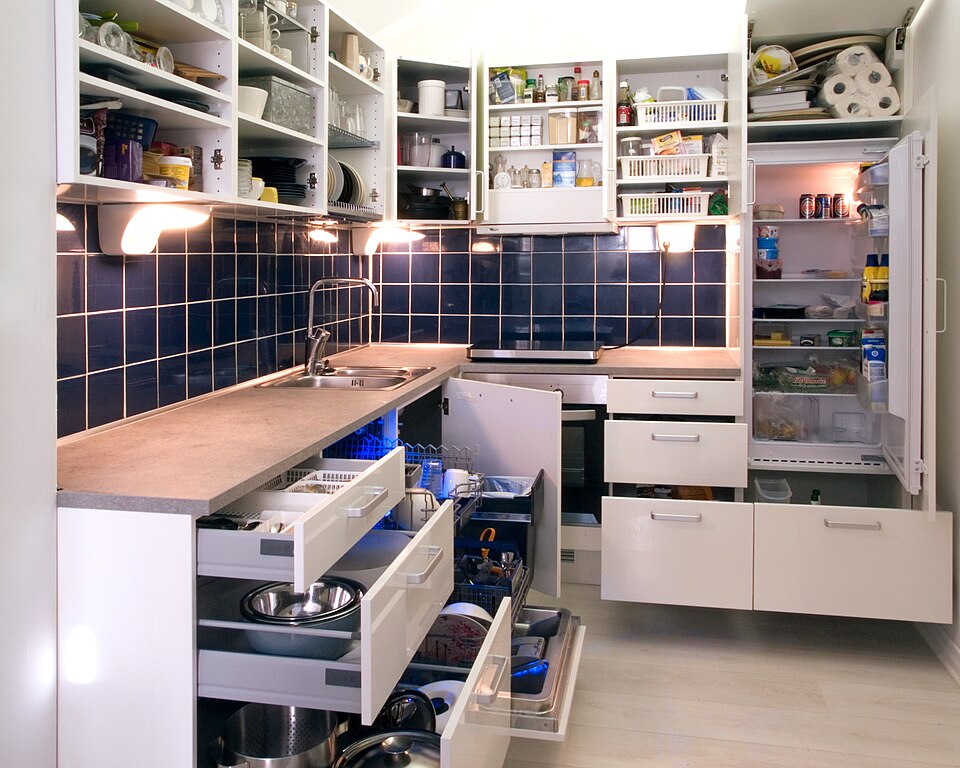 A white kitchen with deep pan drawers pulled open
