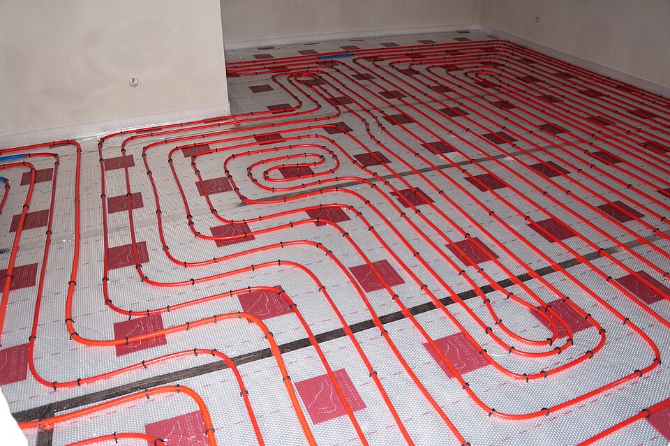 Underfloor heating pipes laid out before the floor is finished