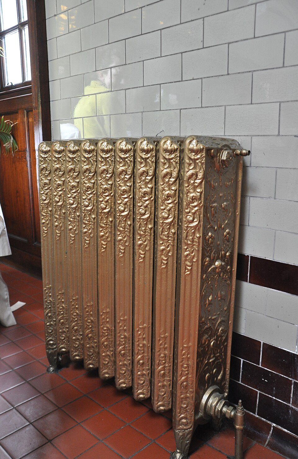 A tall ornate cast-iron radiator in the old kitchen at Pollok House