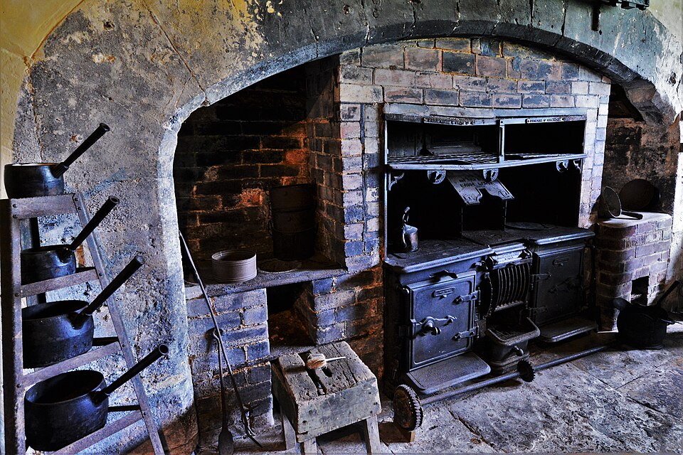 An old iron range set into the great kitchen fireplace at Chastleton House