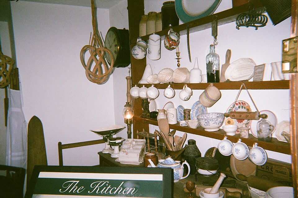 Open kitchen shelves lined with jugs, cups and plates
