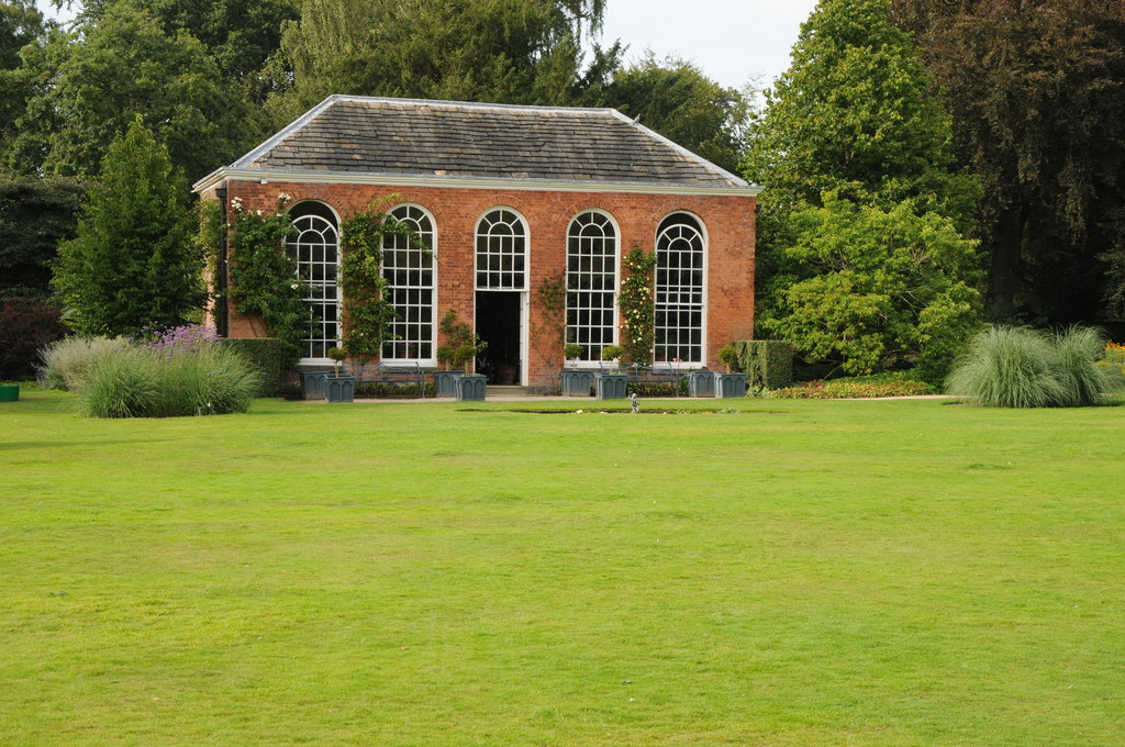 A brick orangery with tall arched windows