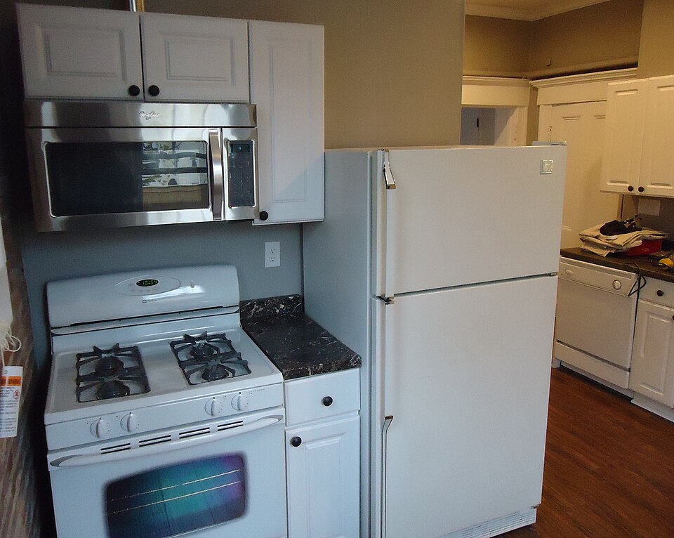 A kitchen with freshly painted white cabinets