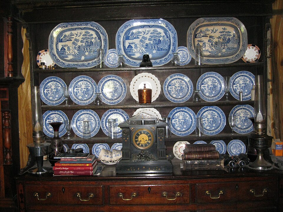A dresser displaying blue and white plates