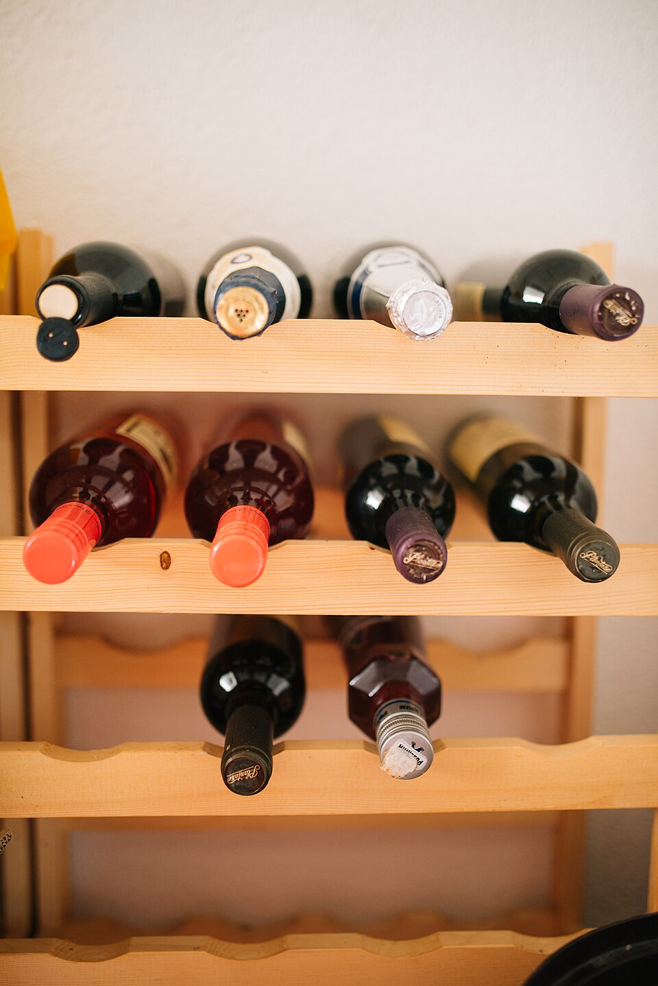 Bottles of wine lying on a wooden wine rack