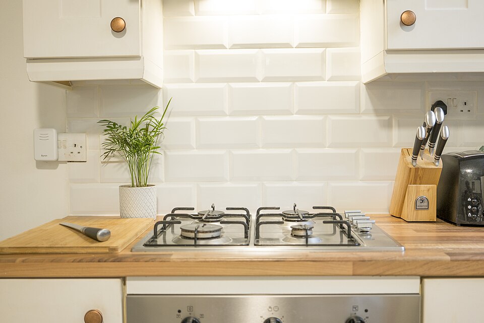 A gas hob set into a wooden kitchen worktop