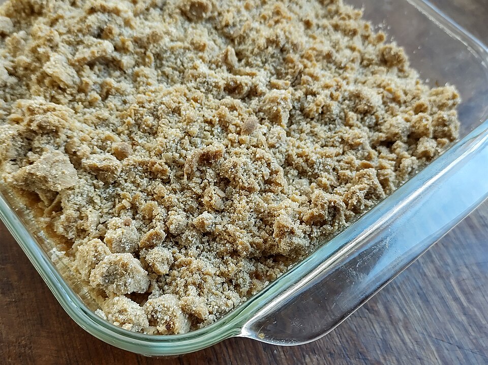 An apple crumble in a glass baking dish