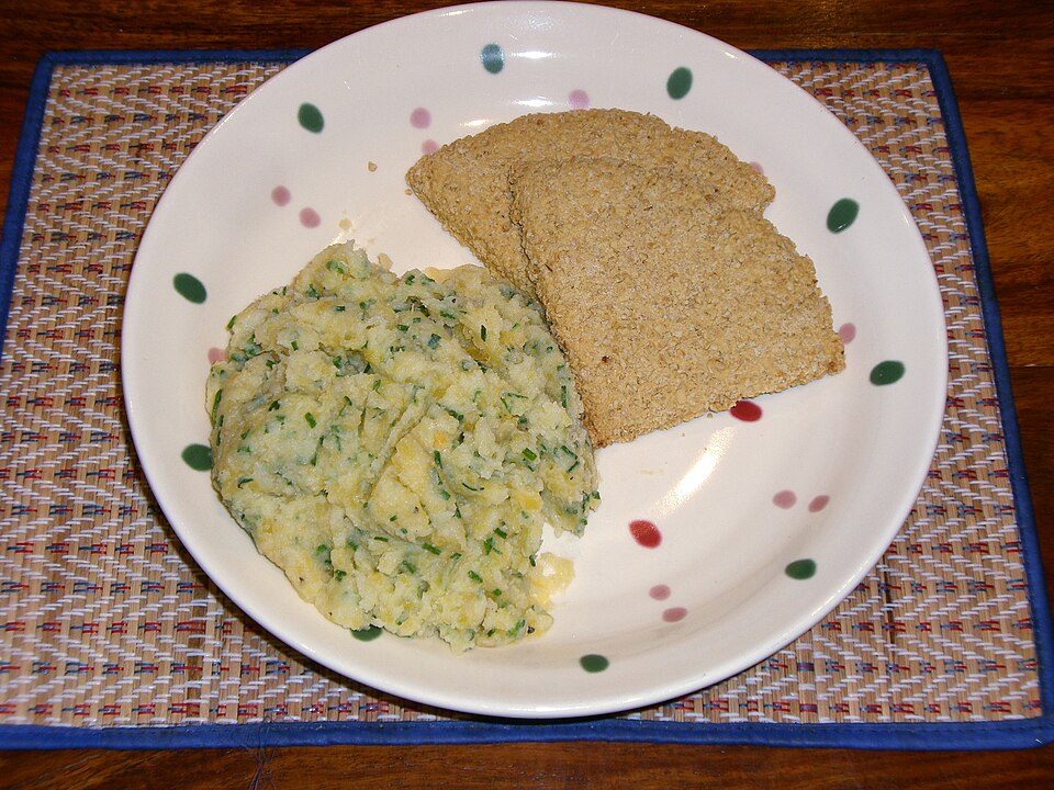 A plate of clapshot, mashed potato and swede with chives, beside oatcakes