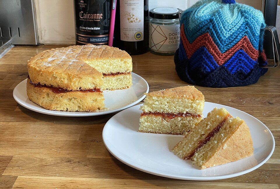 A Victoria sponge with a jam filling, cut into slices