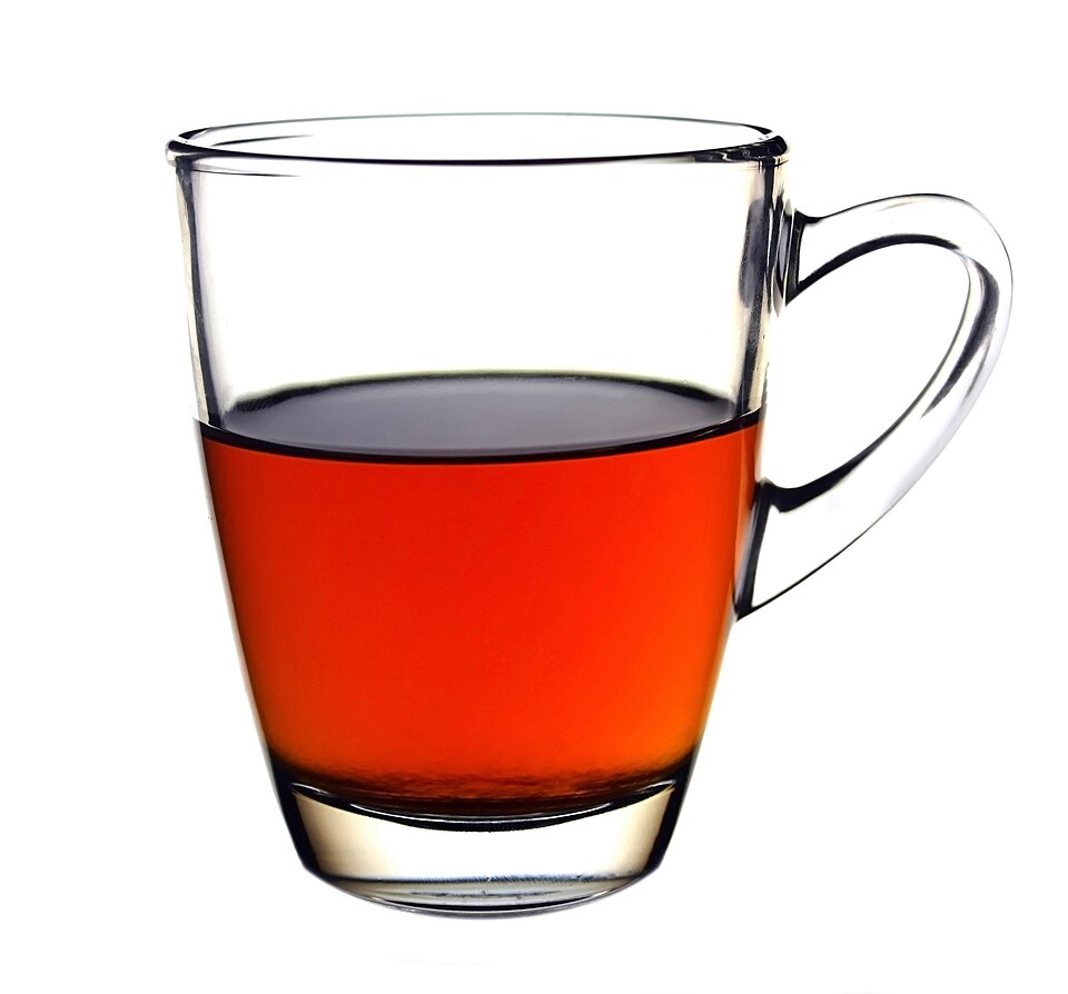 A glass cup of strong black tea