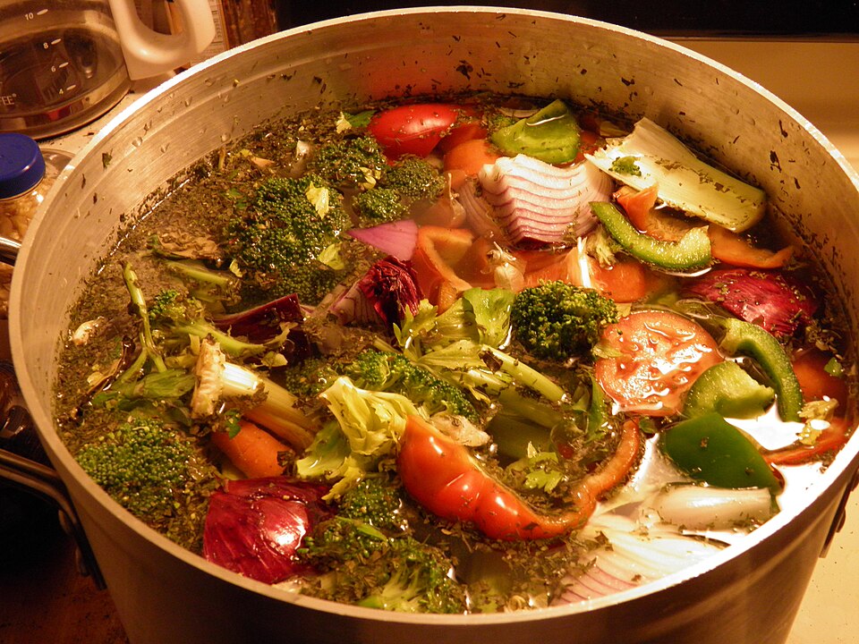 Vegetable soup simmering in a large pot