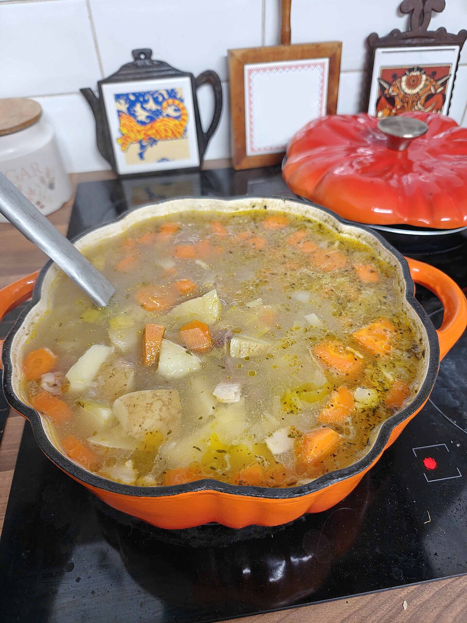 Cawl simmering in a casserole on the hob