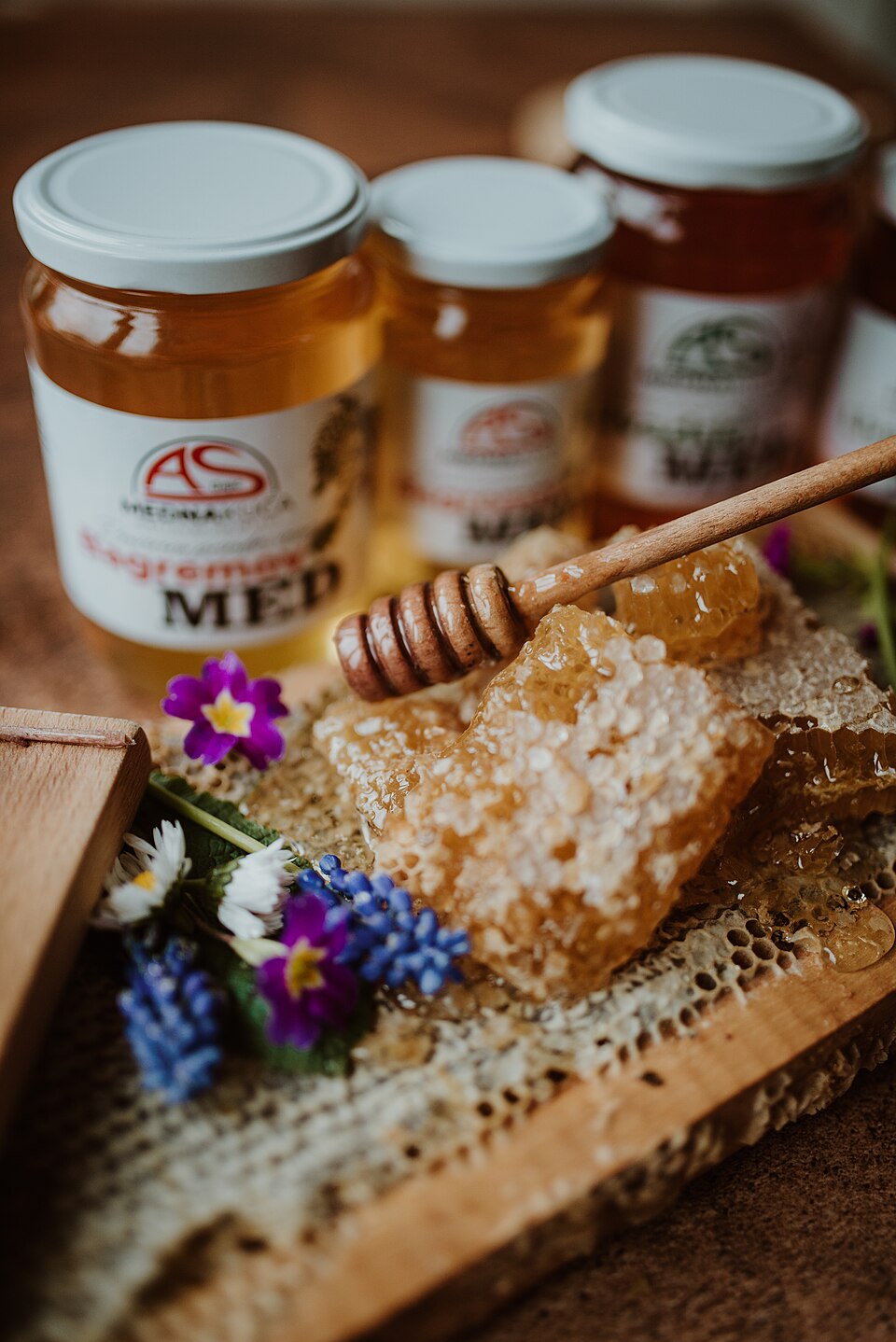 Jars of honey with a honey dipper