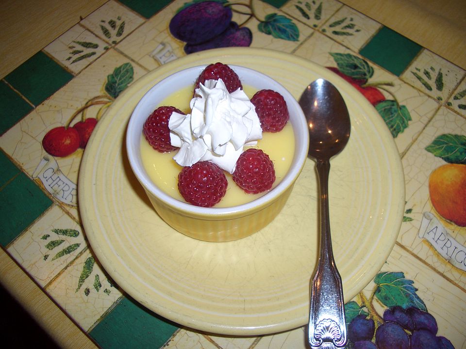Raspberries with whipped cream in a small dish