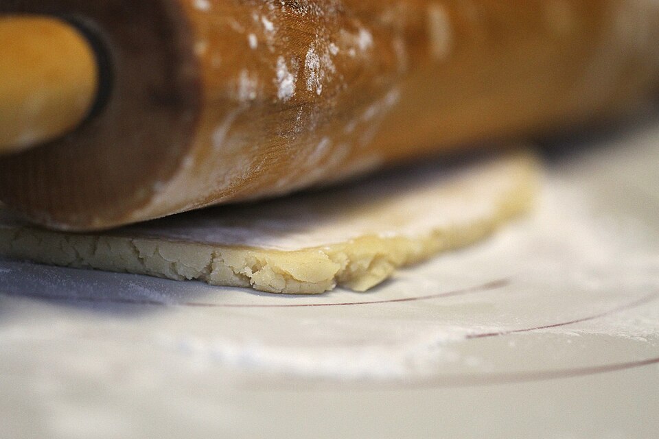 Dough being rolled out with a rolling pin