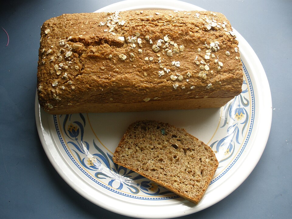 A loaf of Irish brown soda bread with a slice cut