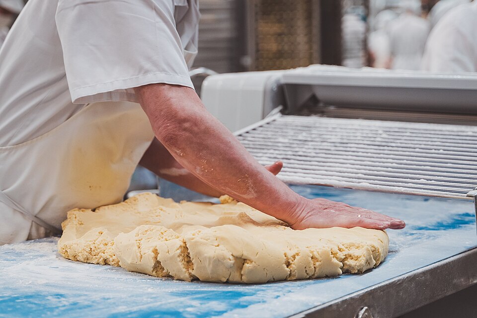 Shortbread dough being pressed out by hand