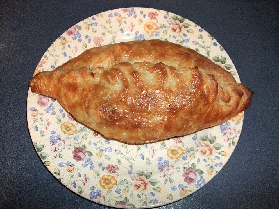 A baked pasty, golden brown