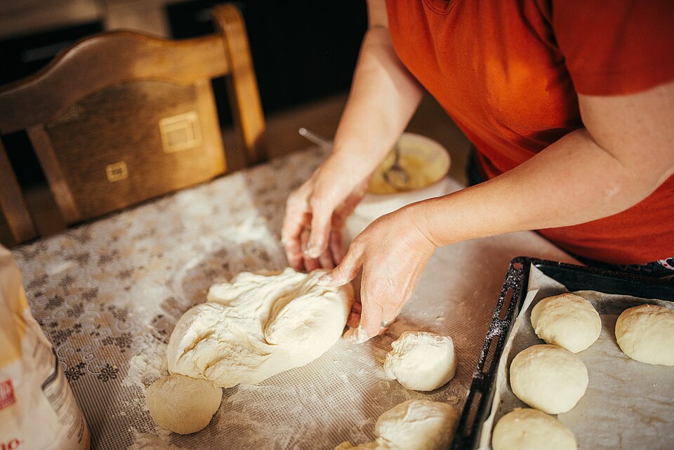 Working pastry dough by hand on a floured table