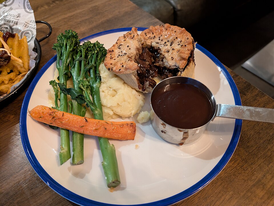 A steak and ale pie split open to show the filling