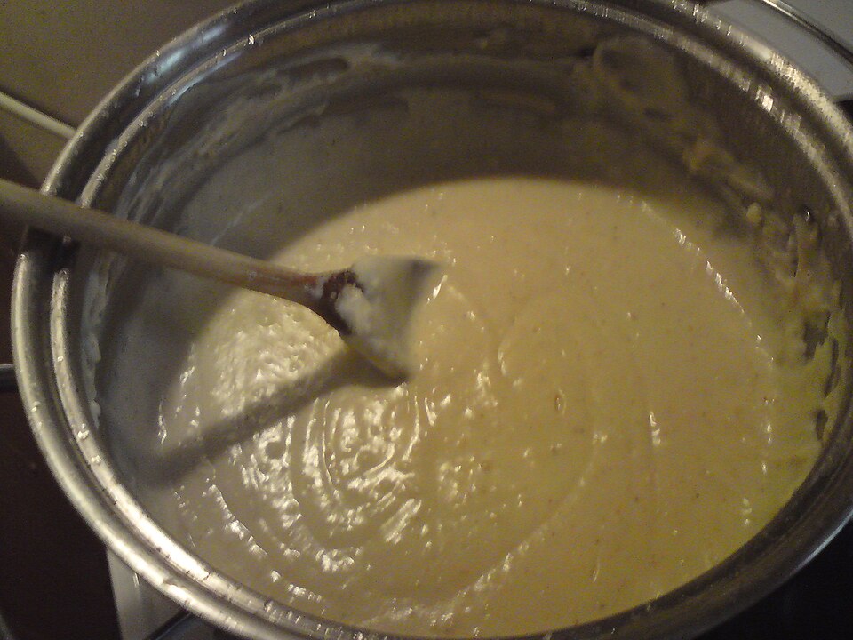 A thick, smooth sauce in a saucepan