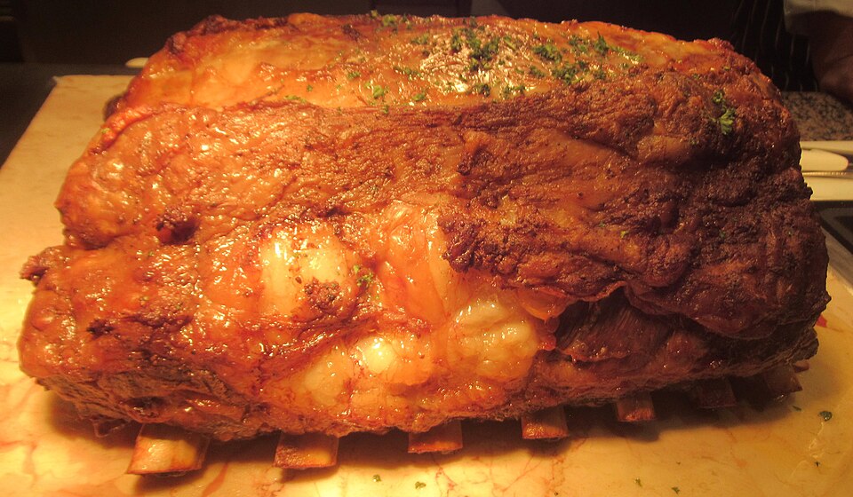 A browned rib of beef resting after roasting