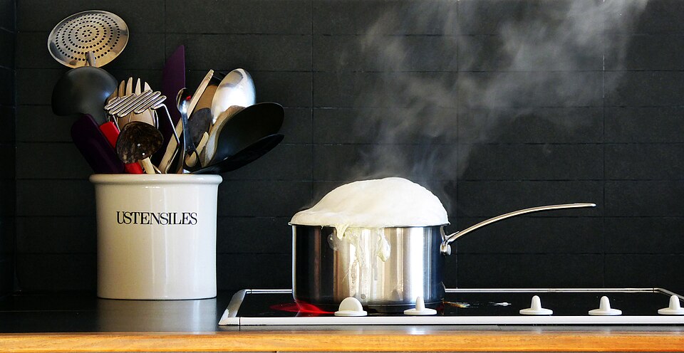 Milk heating in a saucepan on the hob