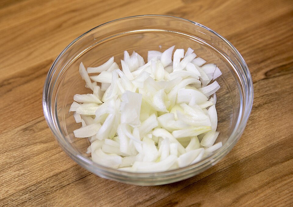 Sliced onions in a glass bowl