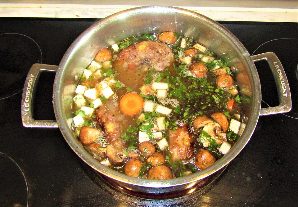 Irish stew cooking in a large pan on the hob