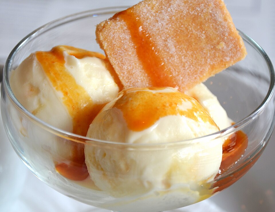 Hot toffee sauce poured over ice cream