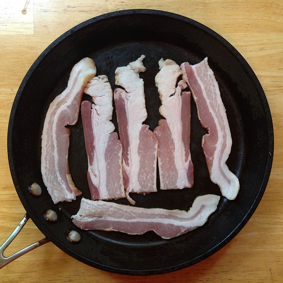 Rashers of bacon in a frying pan