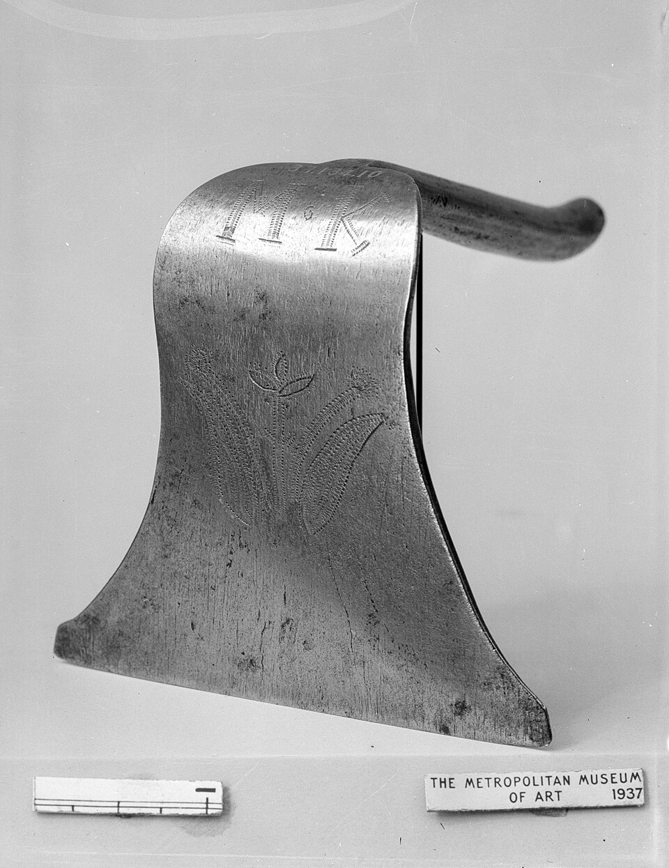 An antique iron dough scraper