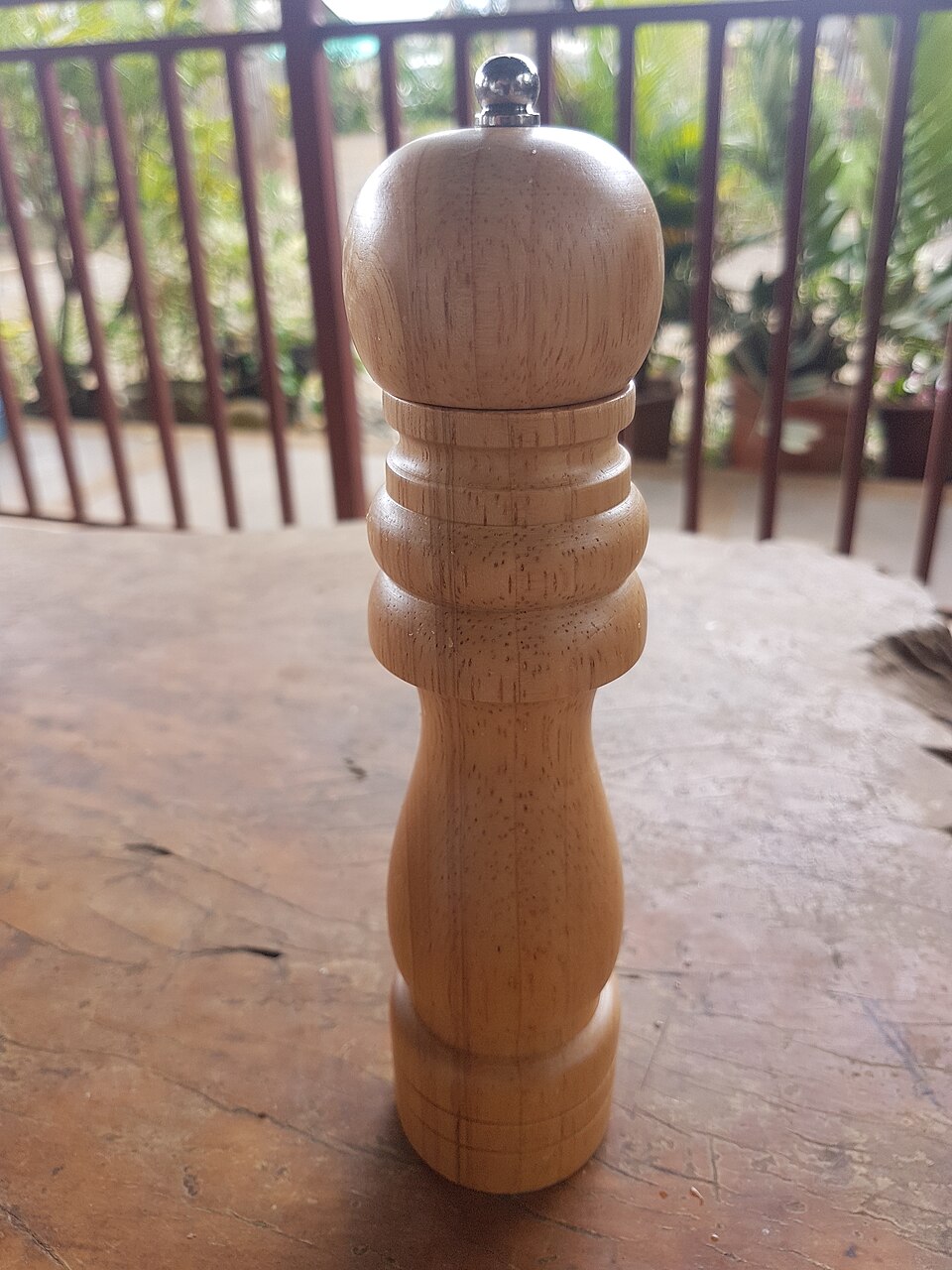 A wooden manual pepper mill