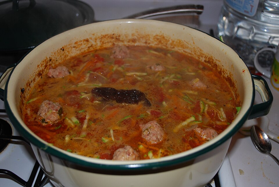 A large enamelled pot of soup on the hob