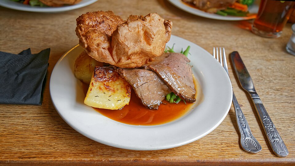 A roast dinner with Yorkshire pudding, roast potatoes and gravy