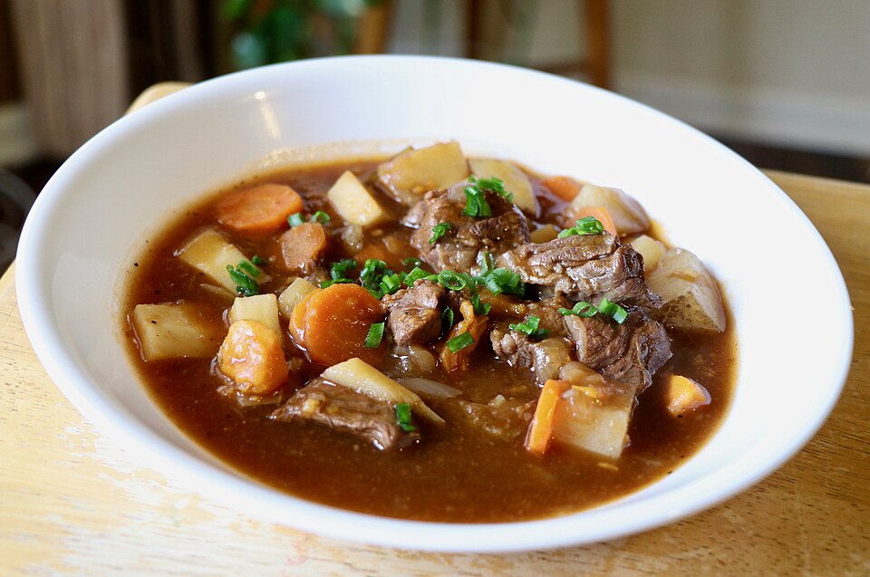 A bowl of Irish-style beef stew with carrots and potatoes