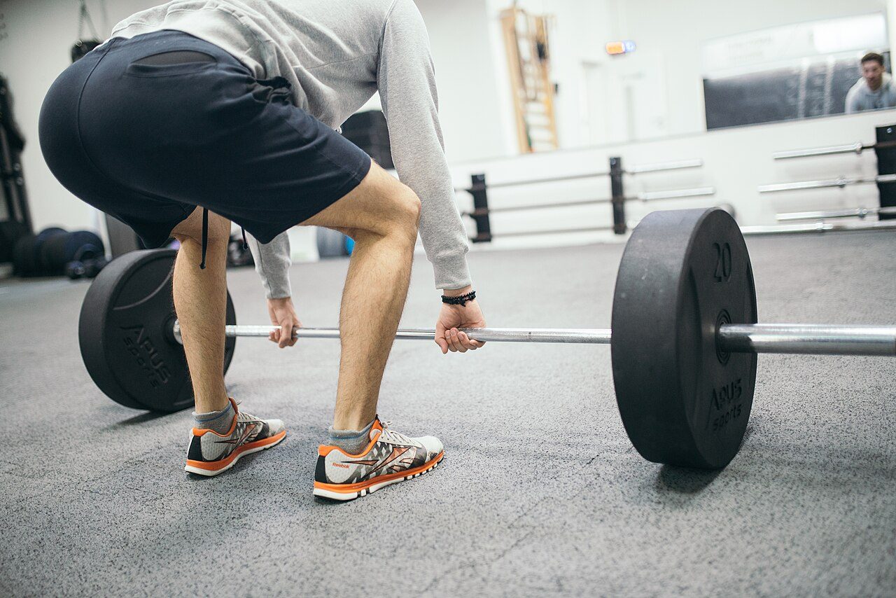 Man lifting a barbell from the floor