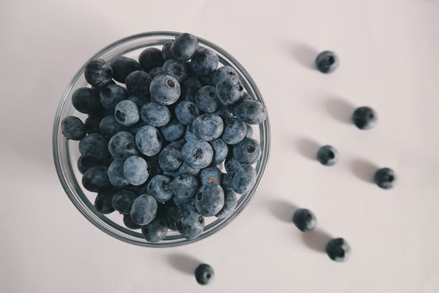 Bowl of blueberries on a pale table