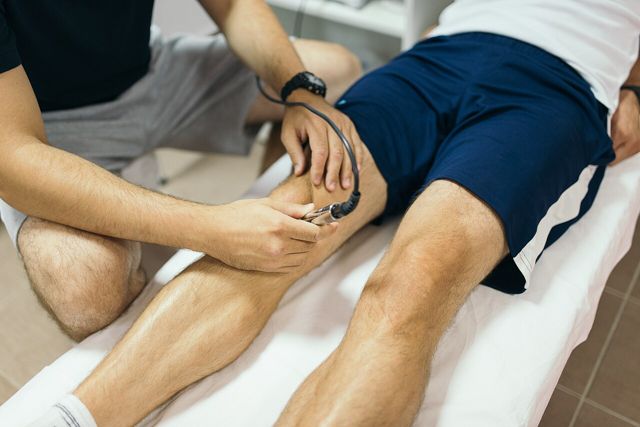 Therapist treating a person’s knee