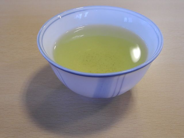 White cup of green tea