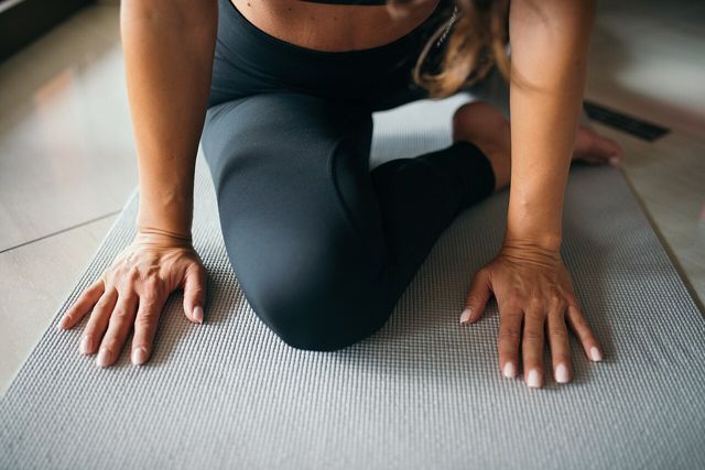 Woman stretching on a yoga mat